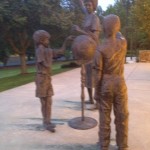 bronze statue teacher with children