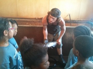 Boys and Girls Club students with farmer at Cedar Creek Fish Farm