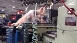 Jesse cutting his piece of plastic on a cnc machine
