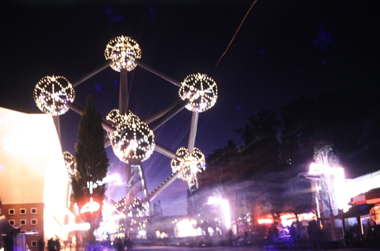 Photo at night of a well lit atom-like structure.