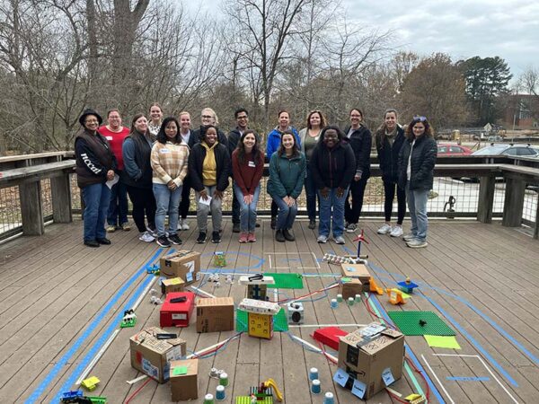 Mountains to Sea Scholars at the Walnut Creek Wetlands Center in Raleigh pose with their model of a climate-resilient city.