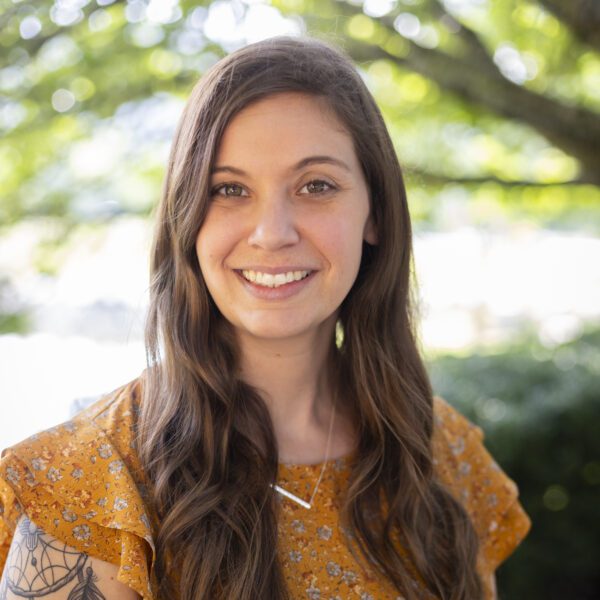 Headshot of Pierce wearing a rust colored blouse.