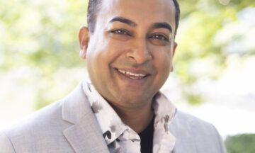 Headshot of Sathy wearing a light colored blazer.