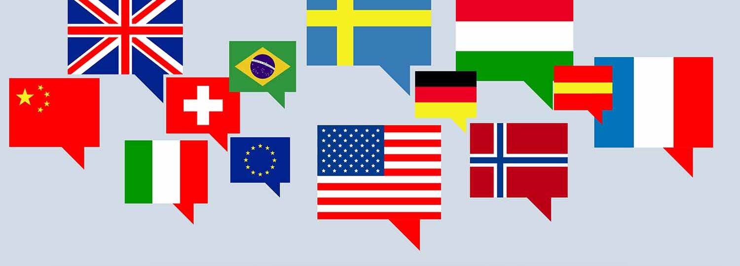 Multilingual graphic. Gray background with international flags and chat boxes.