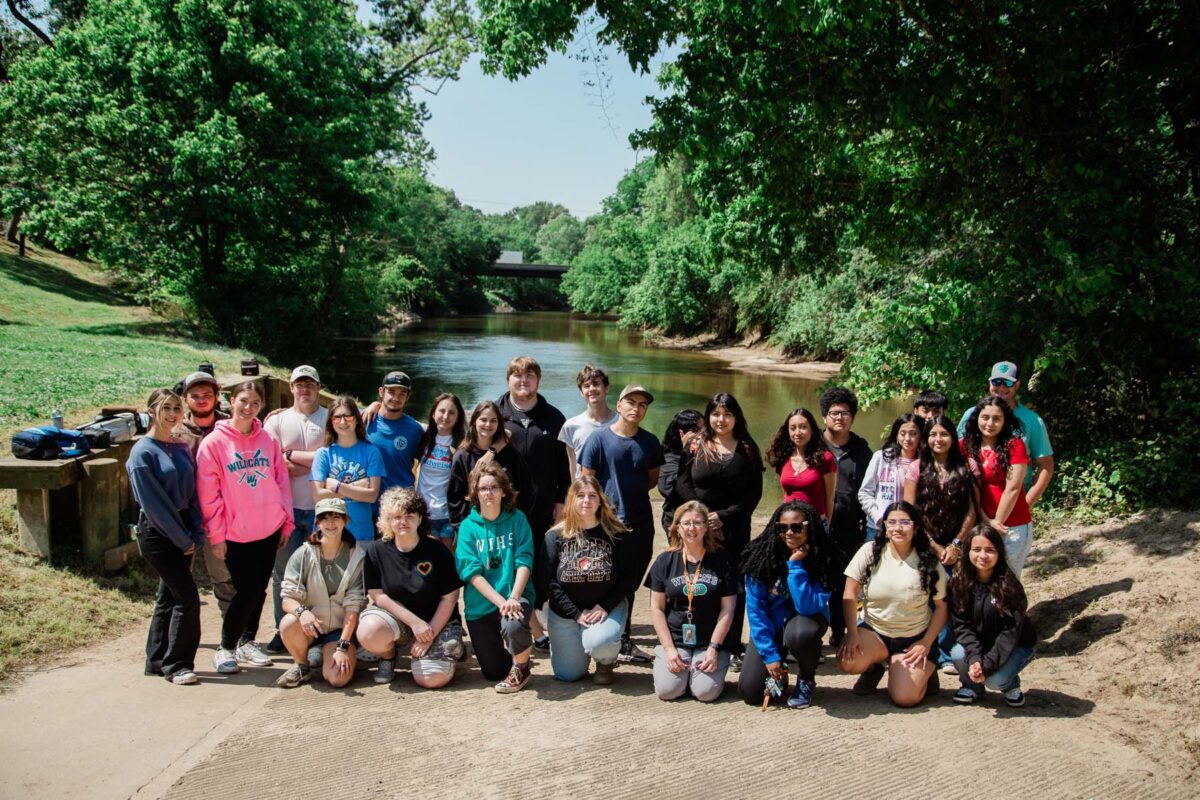 Group photo of Janice West's high school students pose in front of the Neuse River.