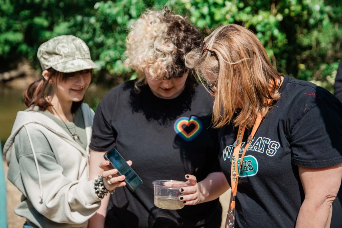 Students check the river's water quality.