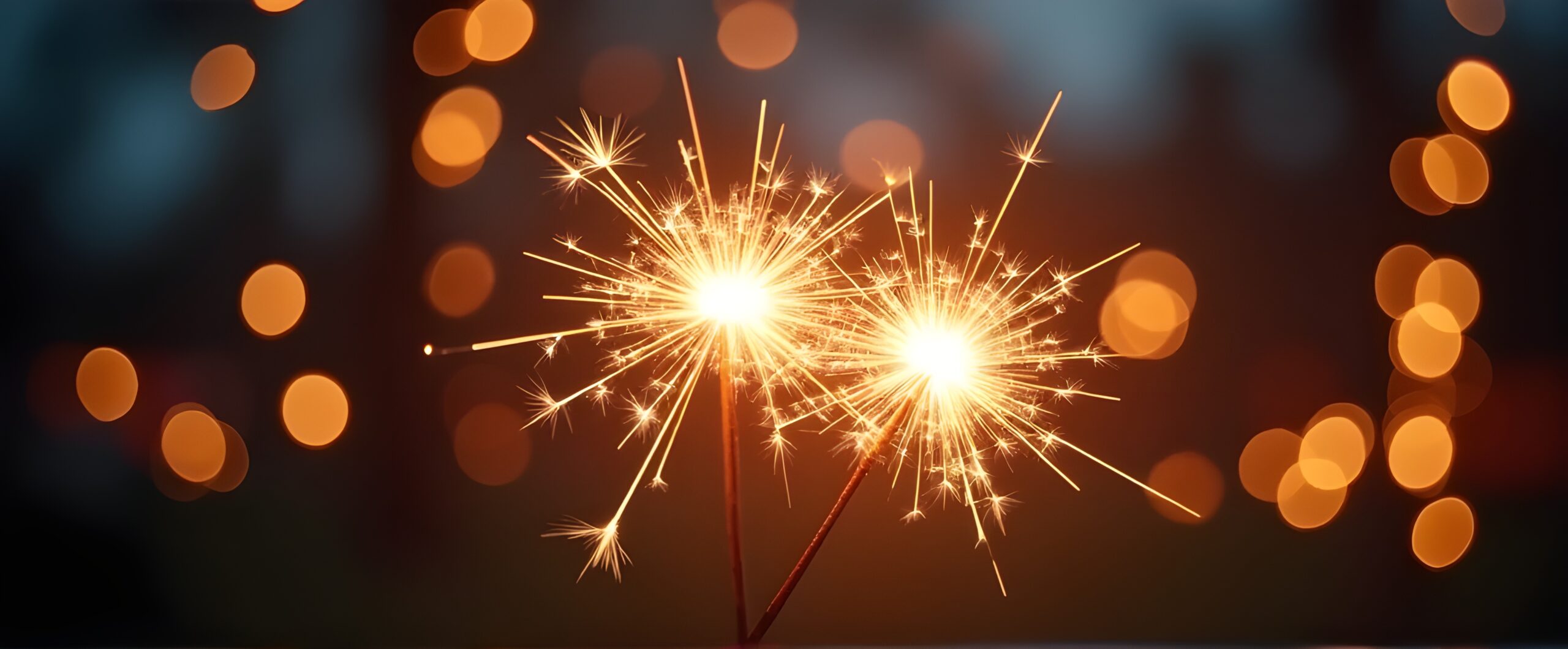 Hands holding burning sparkler with bokeh light background, copy space for text, background for diwali - festival of lights.