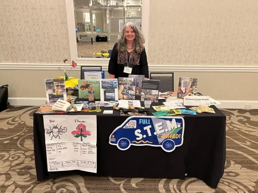 Renata Crawley stands at a display for her STEM van.