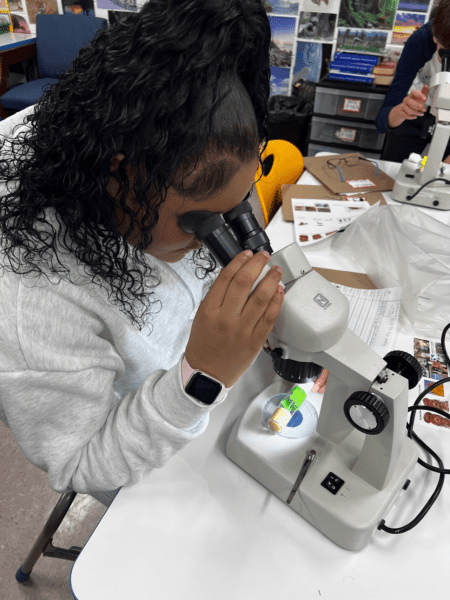 Christine Suzina leading the fruit fly lab with her students.