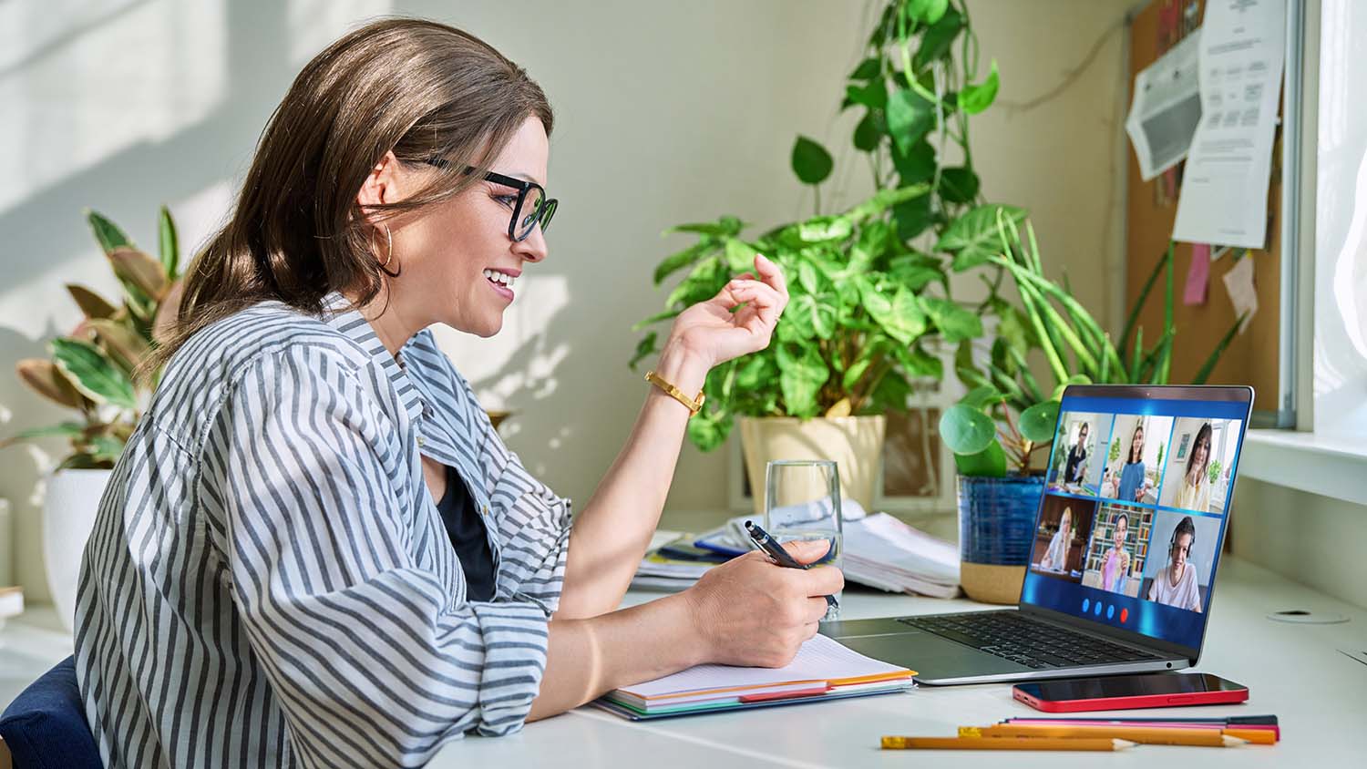 Female teacher working at home remotely, online lesson with group teenage students, teaching looking at laptop screen sitting at home. Distance virtual class course interactive lesson video conference