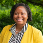 Outdoor portrait of STEMwork participant DaChelle Gupton wearing a yellow blazer.