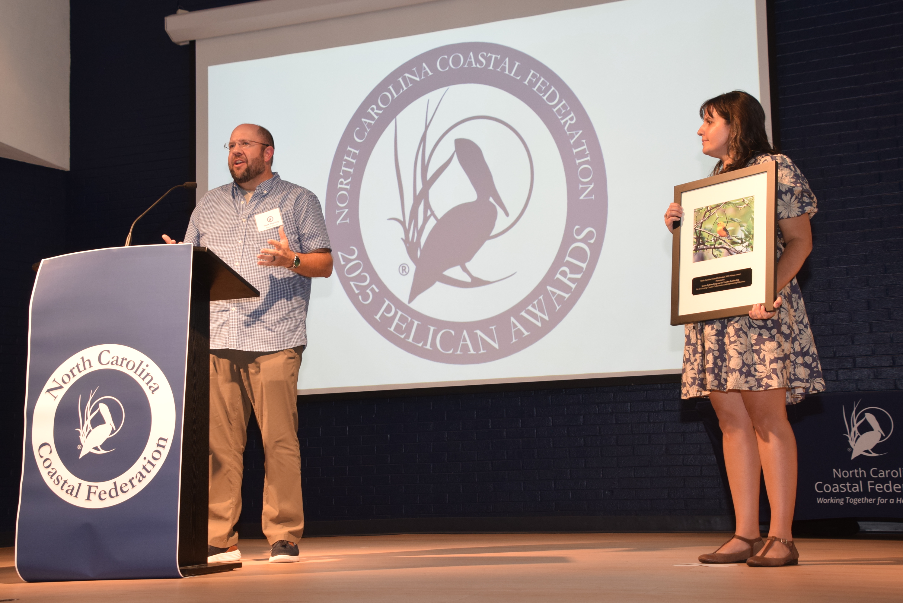 KFP staff members Mark Townley accepts the Pelican Award