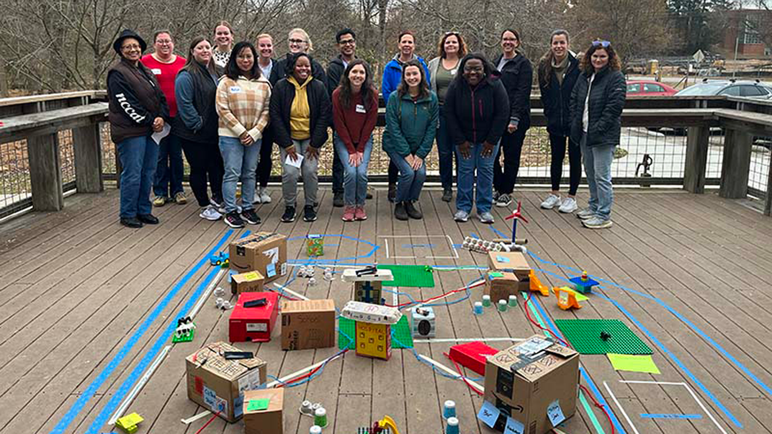 Educators in the Mountain to Sea professional development place-based learning institute show off their cardboard city