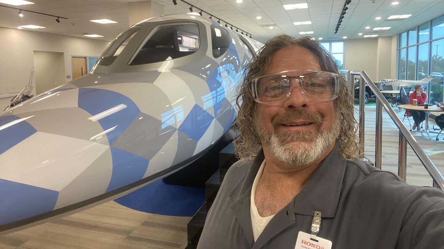 Mark Case, a high school science teacher in Guilford County, NC, poses next to small airplane at Honda Aircraft.