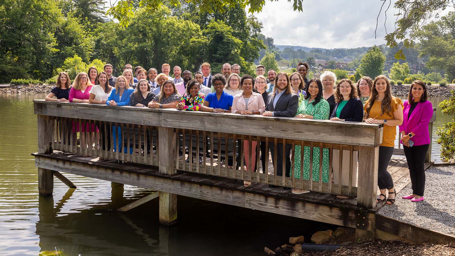 The 2024-25 cohort of Kenan Fellows pose for a group photo on a dock during the Kenan Fellows Program for Teacher Leadership Summer Institute in the North Carolina mountains.