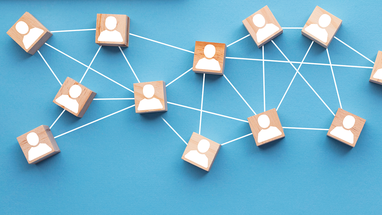 Wooden blocks connected together on a blue background. Teamwork concept